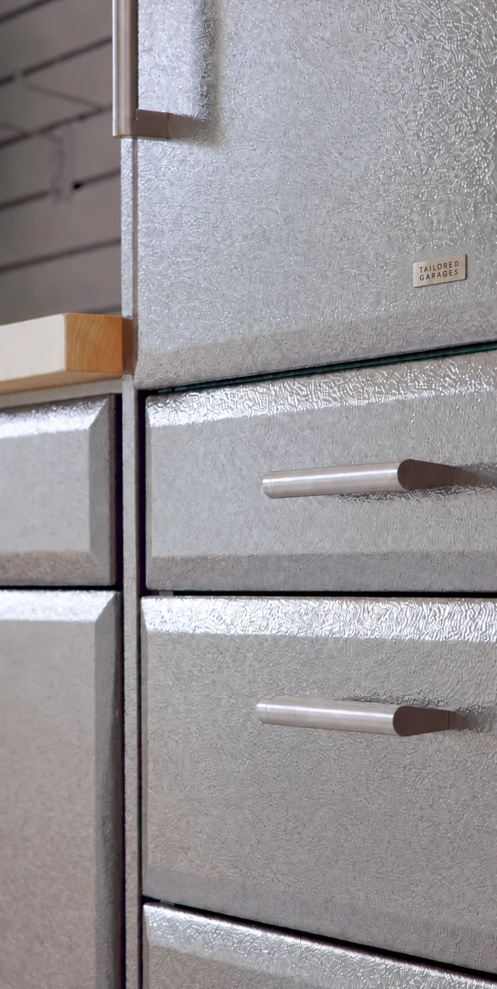 Close-up of textured graphite powder-coated cabinet doors and stainless-steel pulls